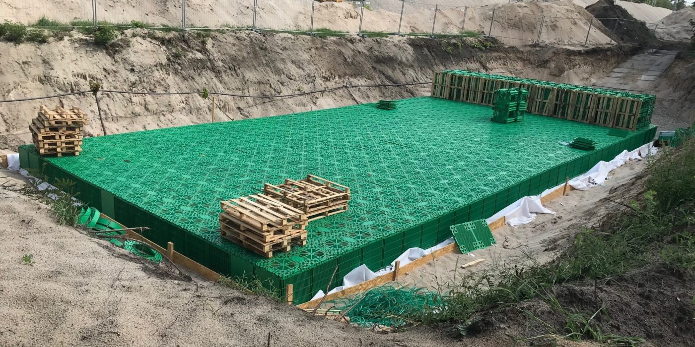 Nearly completed stormwater infiltration tank from Stormbox II crates nearby the railway line | Pipelife