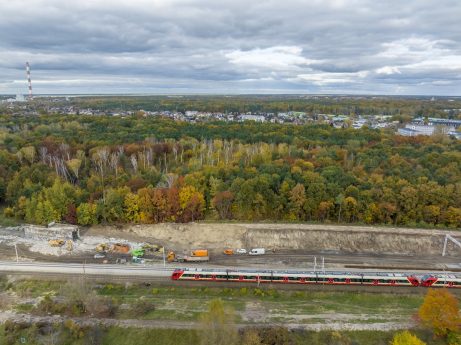 An aerial photo of the LK7 line with a red train moving and construction works taking place nearby the railway | Pipelife